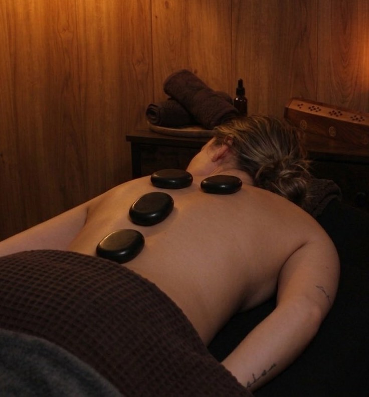 Persona disfrutando de tratamiento spa de piedras volcánicas en HÛ en Santutxu Bilbao